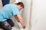 Young Worker Smoothing Wallpaper Stock Photo