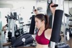 Young Fitness Woman Executed Exercise With Exercise-machine In Gym Stock Photo
