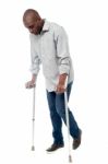 Young Man With Crutches Trying To Walk Stock Photo