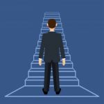 Businessman Standing On Ladder Or Stair Stock Photo
