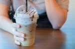 Woman Hand On Iced Milk Coffee Drink Stock Photo