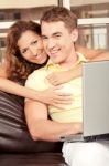 Smiling Love Couple With Laptop Stock Photo