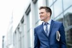 Handsome Businessman Holding A Newspaper Stock Photo