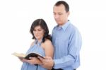 Attractive Couple Reading The Bible Stock Photo