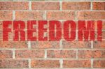 Old Brick Wall Texture With Freedom Inscription Stock Photo
