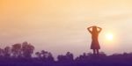 Silhouette Of Woman Praying Over Beautiful Sky Background Stock Photo