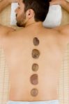 Man Receiving Hot Stone Massage Stock Photo