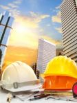 Engineer Working Table Against Sky Scrapper In Urban Scene Use For Land Development And Architecture Occupation Theme Stock Photo