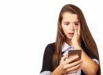 Teenager Girl Looks At Smartphone Display In Surprise Stock Photo