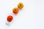 Tomatoes With Glass On A White Stock Photo