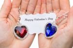 Red And Blue Jewelry Heart With Valentine Card On Hands Stock Photo