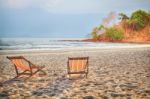 Two Deckchair Canvas On Sand At The Tropical Beach Background Stock Photo