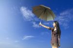 Umbrella And Woman In Blue Sky Stock Photo