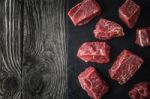 Raw Angus Beef Slices On The Black Stone  On The Wooden Table Horizontal Stock Photo