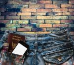 Blue Jeans With Cell Phone, Passport And Flashlight In A Pocket Stock Photo