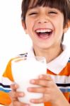 Smiling Young Boy Holding A Glass Of Milk Stock Photo
