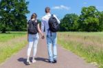 Young Couple Walking Hand In Hand In Nature Stock Photo