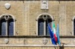 Pienza, Tuscany/italy - May 19 : Flags Attached To The Cathedral Stock Photo