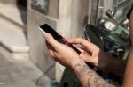 Smartphone In Hands And Moped Stock Photo