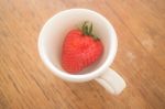 Single Fresh Ripe Strawberry In White Mug Stock Photo