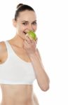 Woman Eating Green Apple Stock Photo