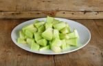 Sliced Melon With Plate On Wooden Background Stock Photo