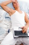 Man Resting With Laptop Stock Photo