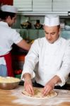 Male Chefs Working In Kitchen Stock Photo