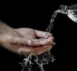 Water Flowing Into Hand Stock Photo