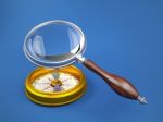 Magnifying Glass Investigate Golden Compass Stock Photo