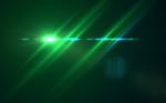 Abstract Design Natural Green Lens Flare And Rays Background.lens Flare Light Over Black Background. Easy To Add Overlay Or Screen Filter Over Photos Stock Photo