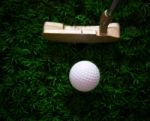 Golf Ball On Green Grass And Putter Stock Photo