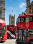 London Buses Next To Westminster Abbey Stock Photo