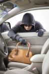 Thief Stealing Handbag From Car Stock Photo