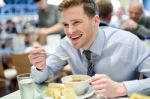 Smiling Young Businessman Having Lunch Stock Photo