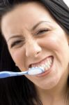 Close Up Of Woman Brushing Her Teeth Stock Photo