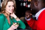 Young Couple Having Conversation In Bar Stock Photo