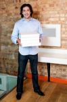 Smiling Man Holding Pizza Boxes Stock Photo