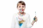 Cheerful Little Messy Girl Painter Stock Photo