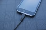 Mobile Phone Charging With Solar Energy - Charger Stock Photo