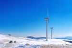 Wind Turbine And Blue Sky In Winter Landscape Stock Photo