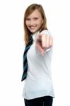 Cheerful Young Girl Pointing Towards The Camera Stock Photo