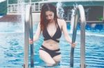 Young Sexy Girl In Black Bikini At Swimming Pool Stock Photo