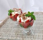 Strawberries With Biscuit Pieces With Mint Whipped Cream Under Stock Photo