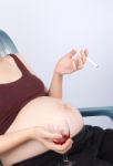 Pregnant Lady with wine cigarette Stock Photo