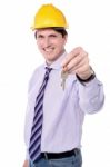 Happy Male Builder Offering New House Keys Stock Photo