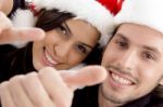 Close Up View Of Young Couple Wearing Christmas Hat And Looking At Camera Stock Photo