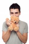 Man Cuddling Teddy Bear Stock Photo