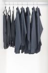 Black Clothes Hanging On Rail Stock Photo
