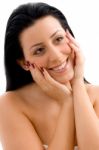 Portrait Of Smiling Female Touching Her Face Stock Photo